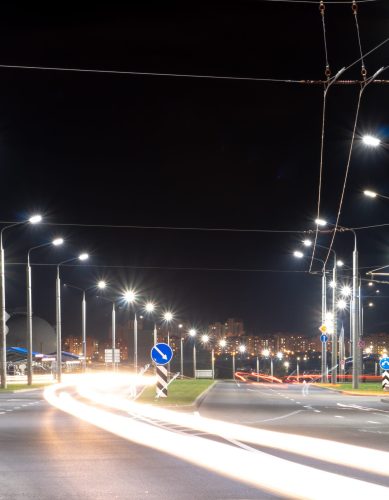 Night city light lines from cars. cars in highway with blur motion. Street view of the modern city at night. A lot of light from car headlights, advertising banners and night lights.